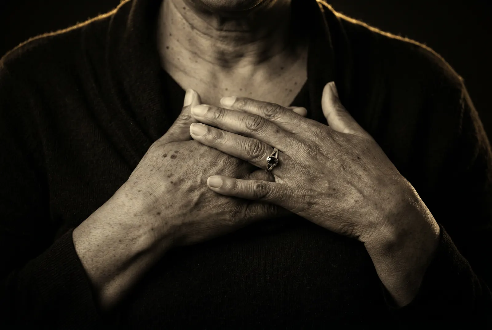 A quiet, human moment — hands resting gently, a portrait of self-care and intention
