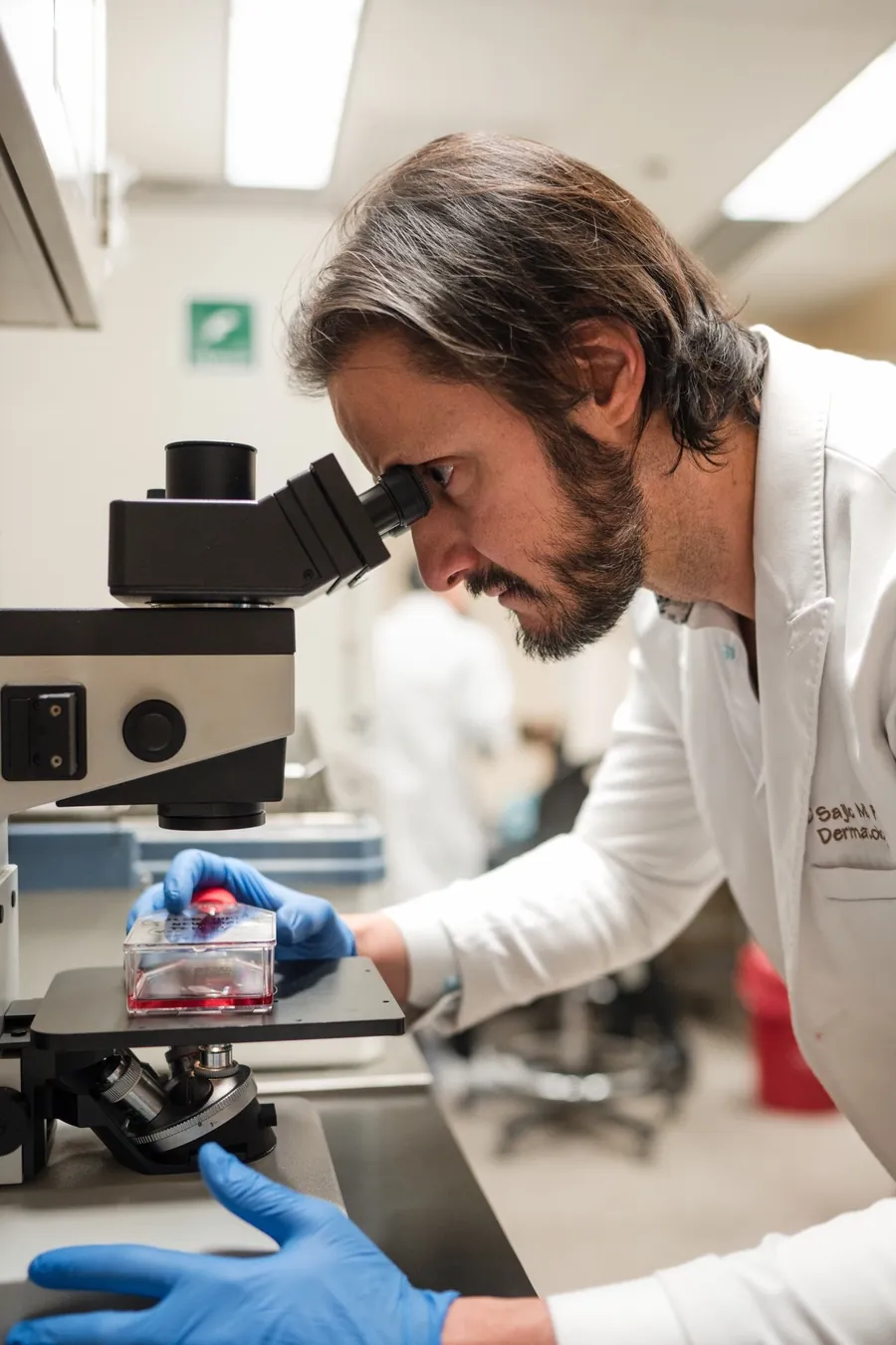 Dr. Sajic at the microscope in the lab